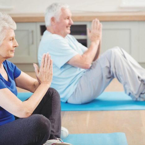 Senior-couple-performing-yoga