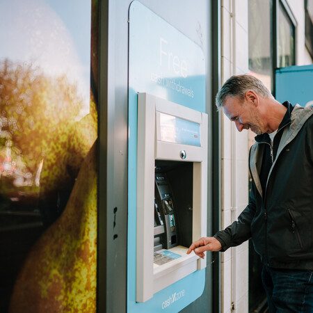 A man using a cash machine.