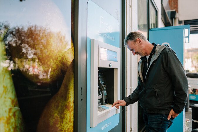 A man using a cash machine.