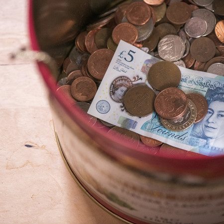 Pot of money on a table.